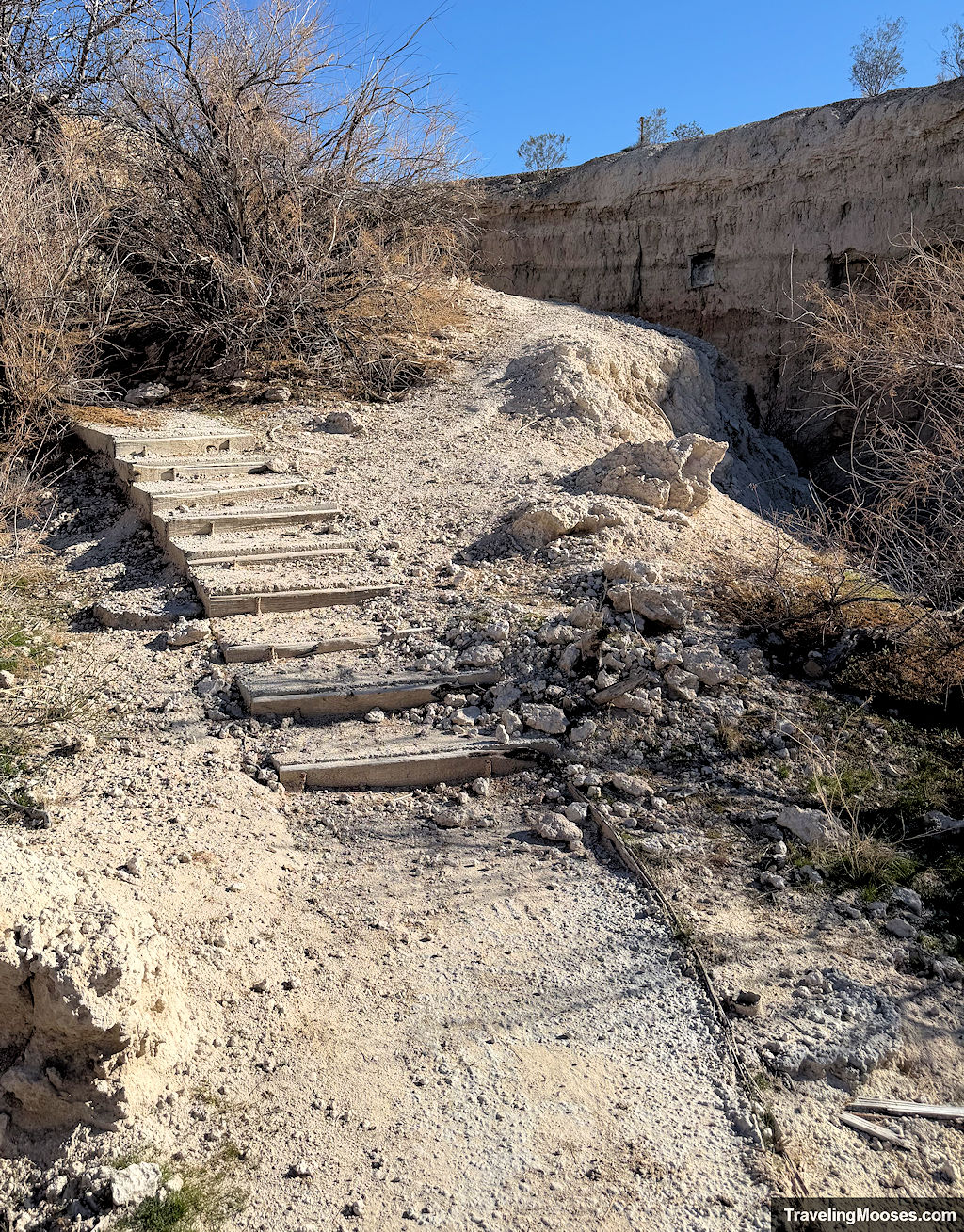 Decaying wooden stairs leading up through a canyon