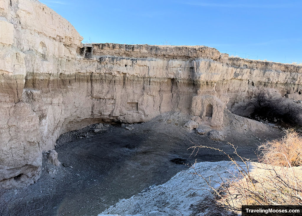 Canyon walls with carved shapes in the walls like a fireplace or window