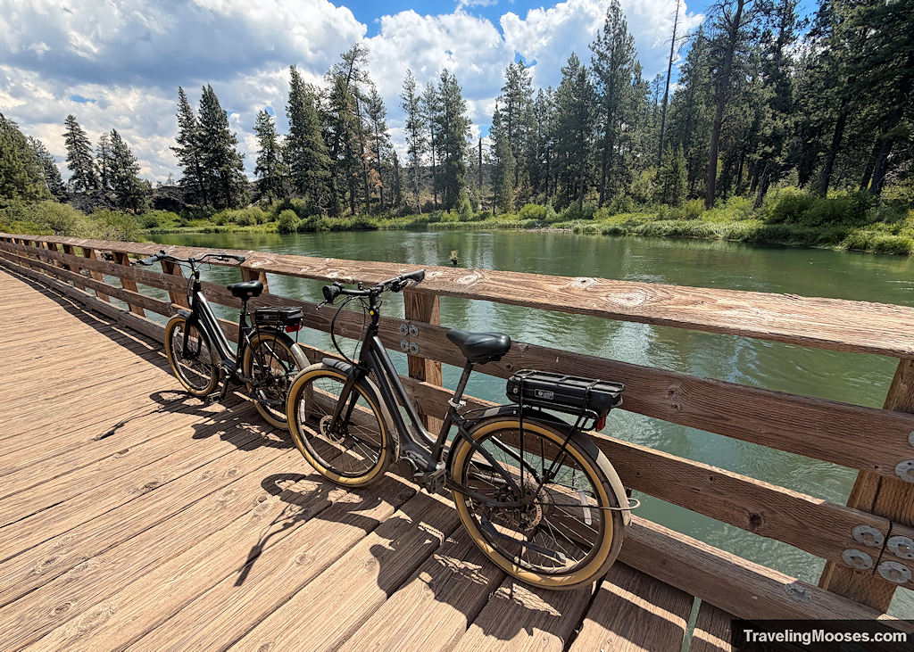 Bikes resting on a wooden bridge by a river
