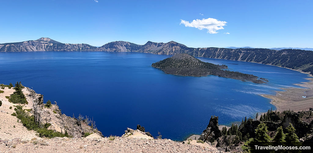 Blue emerald lake shimmering with a large island in the middle
