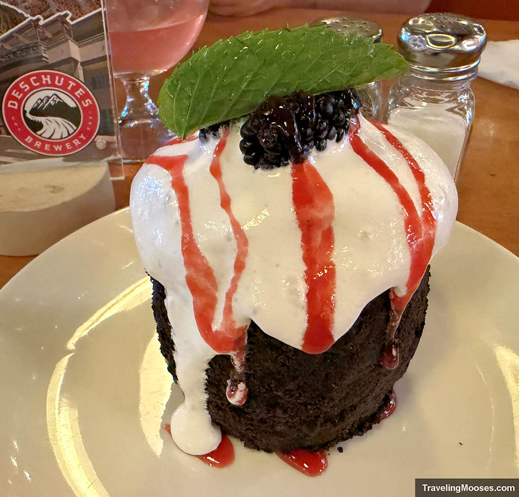 Chocolate volcano desert with whipping cream and a berry on top