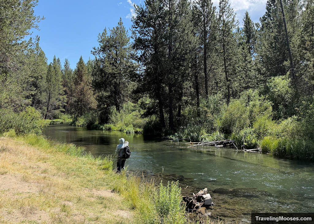 Fisherman walking along the banks of a mellow river
