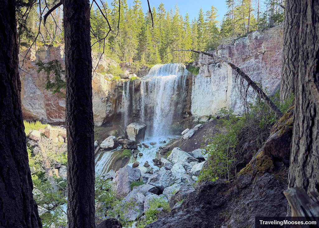 Water falling over red cliff area