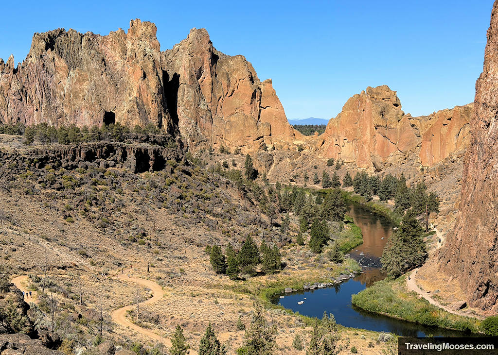 Jagged mountains rising from a valley with a lazy river wandering through