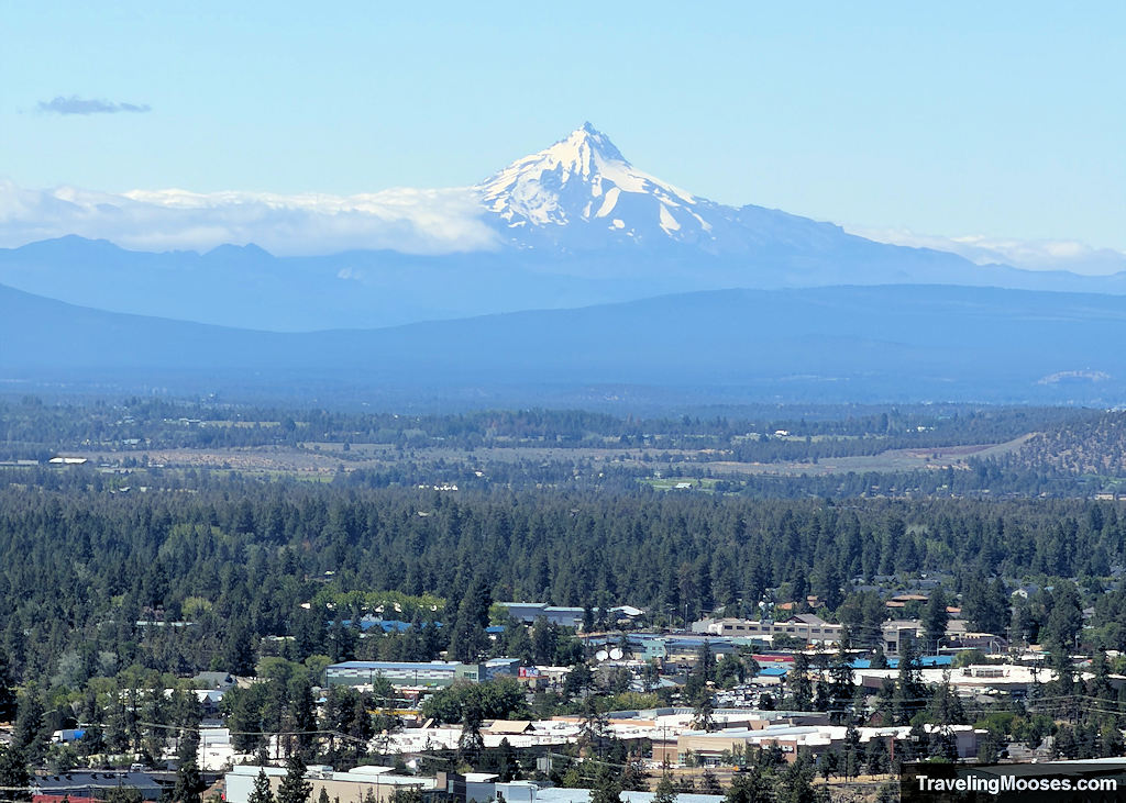 Snow capped mountain above a city