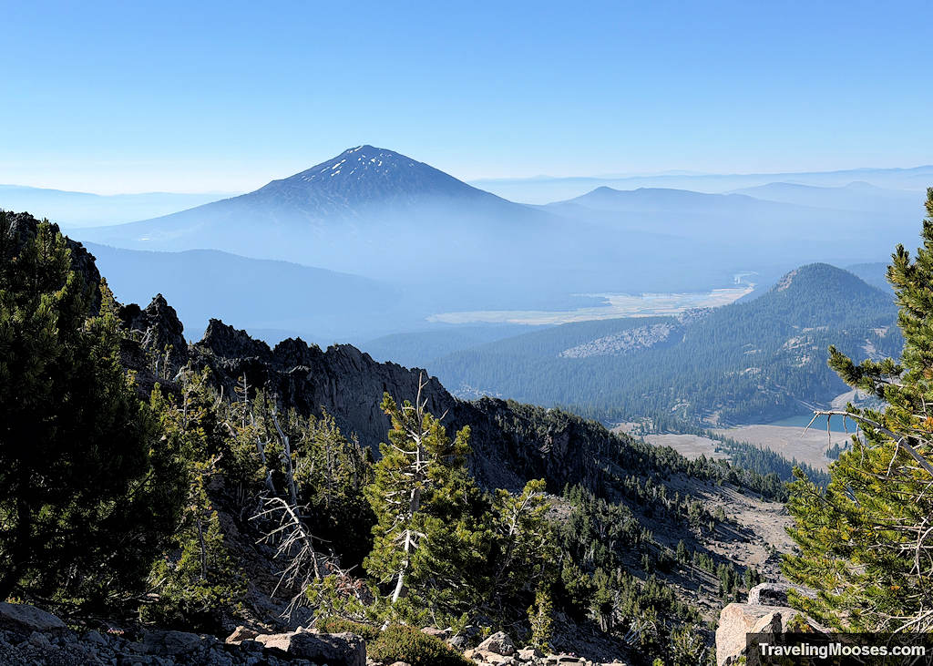 Large dark volcano standing tall shrouded in smoke