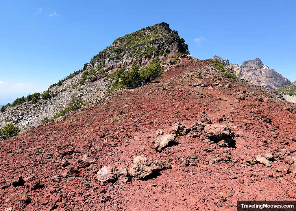Steep red cinder ridge leading directly up toward the rocky, rugged summit block of Broken Hand
