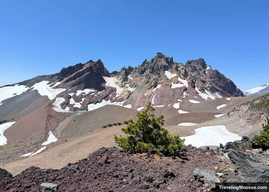 Jagged volcanic crags of Broken Top with a turquoise slice of No Name Lake resting in the glacial crater bowl below