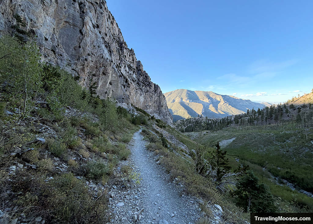 Trail shrouded in sunset near large granite cliffs