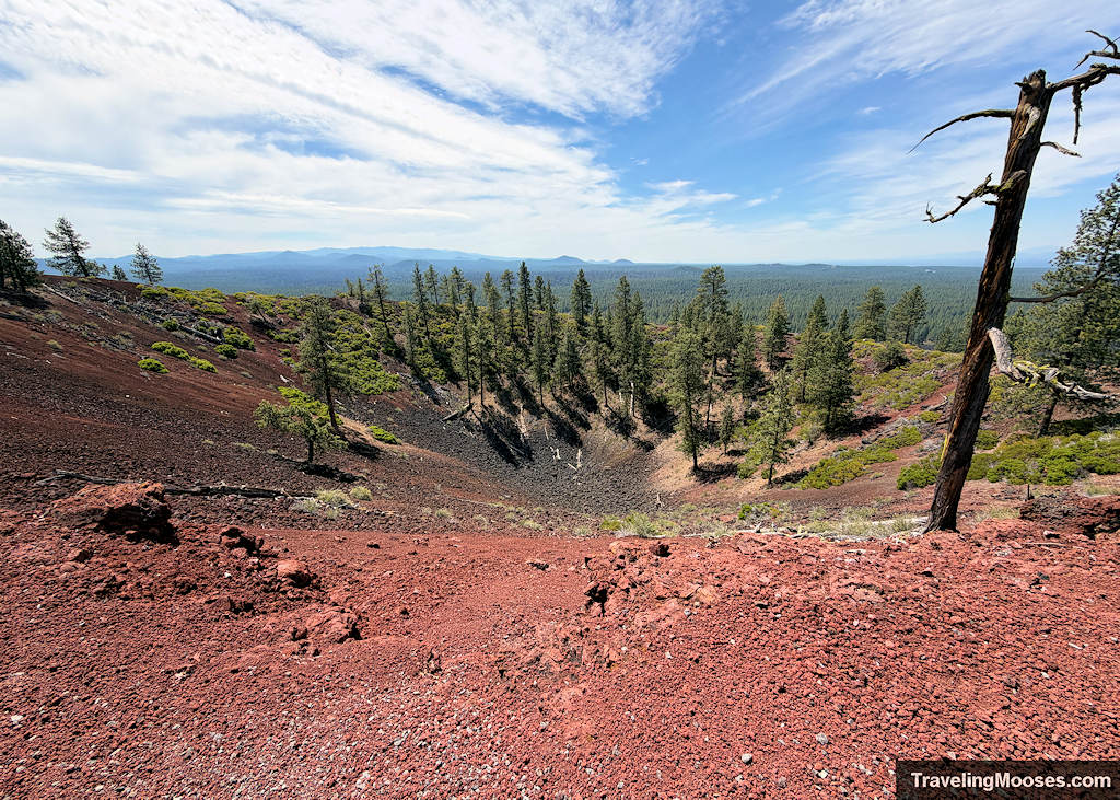 Large crater surrounded by red lava rock