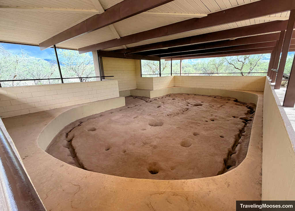 Excavated dirt floor of an ancient Sinagua pithouse sheltered under an open-air pavilion at Montezuma Well National Monument.