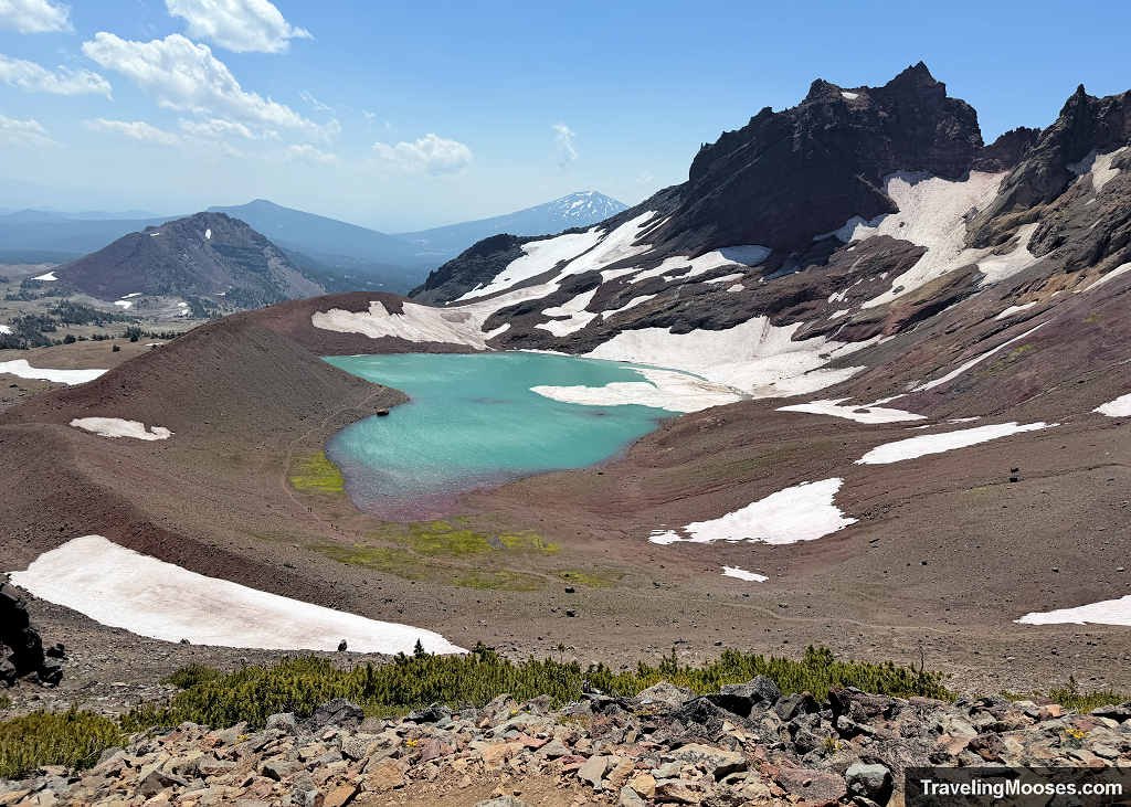 No Name Lake surrounding the jagged mountains of broken top with Mt Bachelor visible