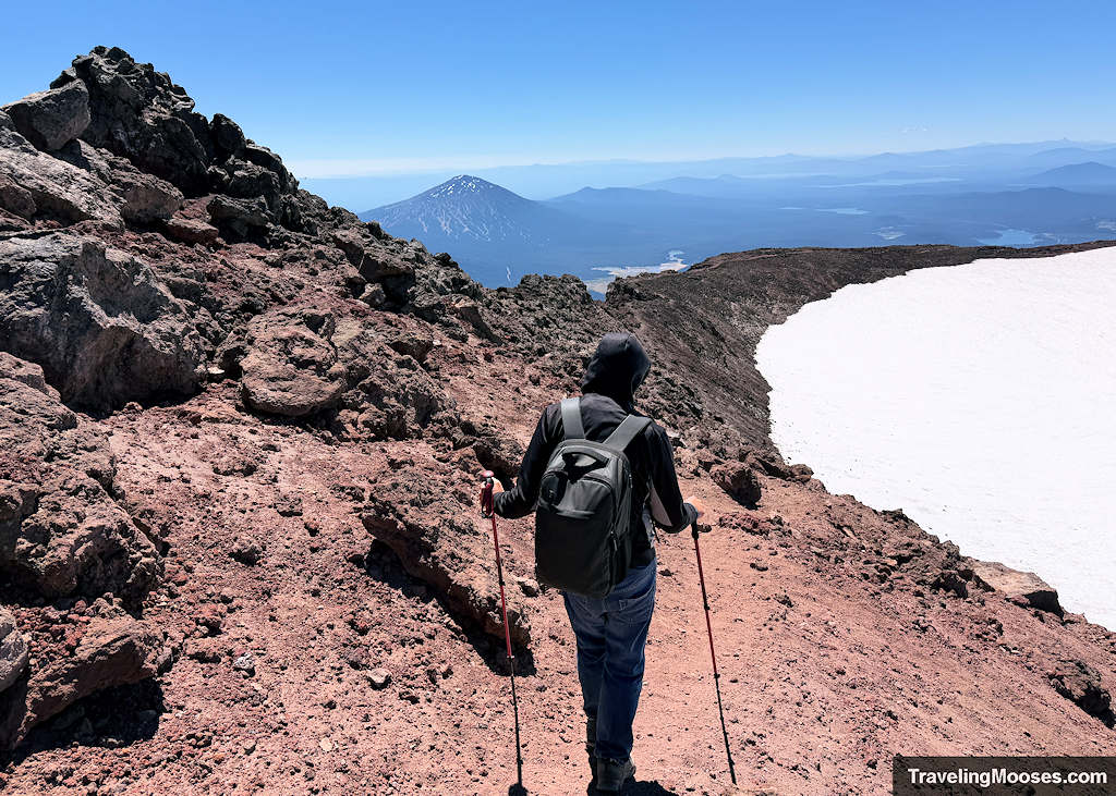 Man walking down the South Sister Rim