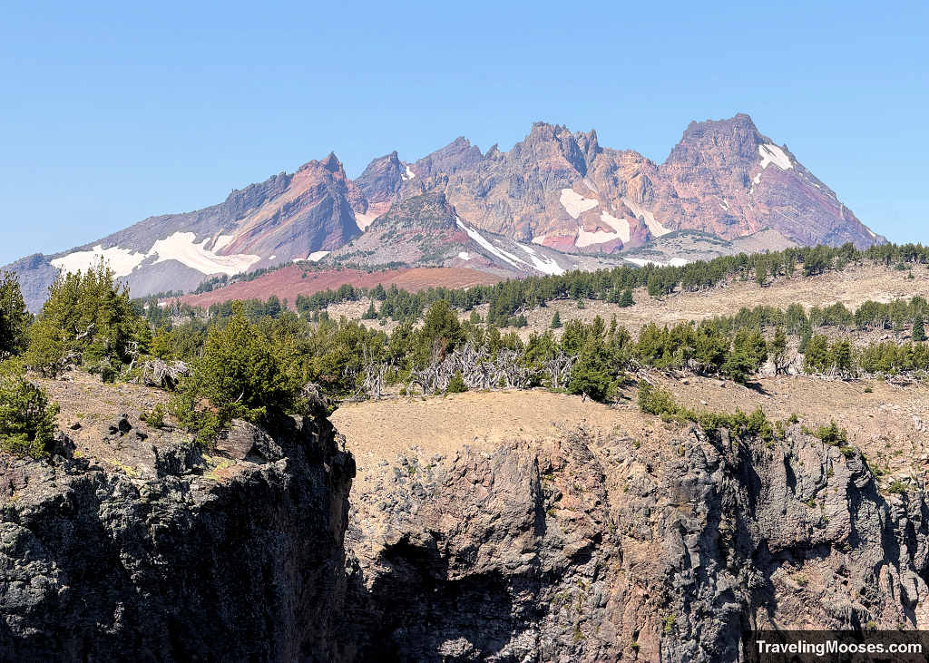 Dramatic jagged volcanic peaks of Broken Top and snowfields viewed across the rim on the Tam McArthur Rim Trail
