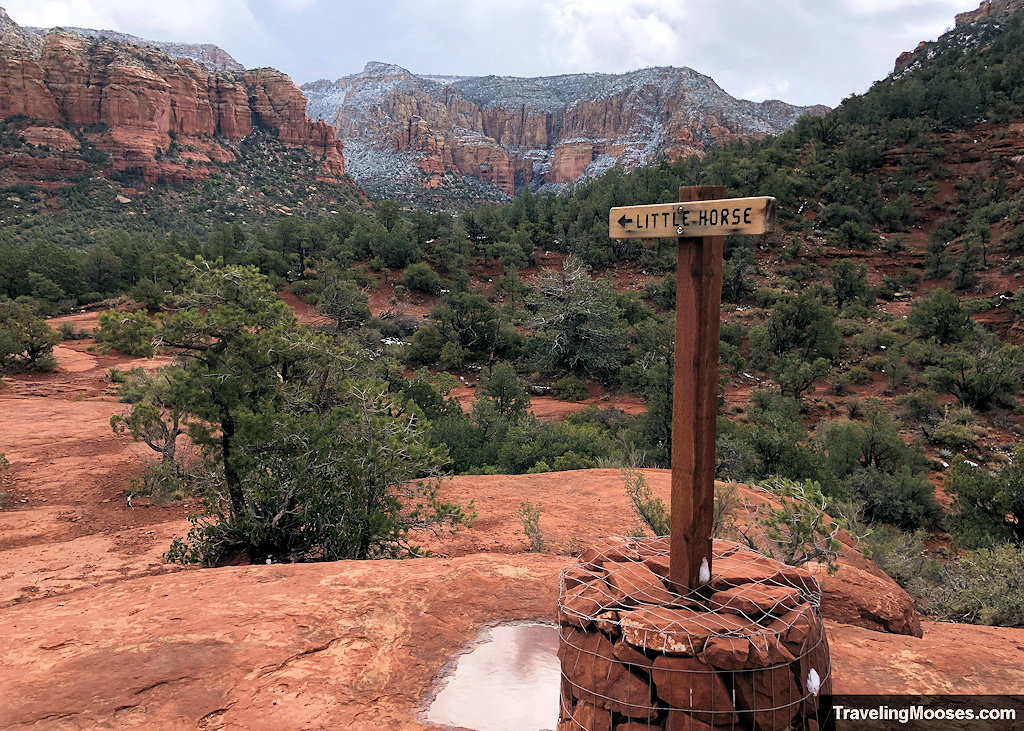 Wooden Little Horse trail sign mounted in a wire-wrapped rock cairn overlooking a canyon