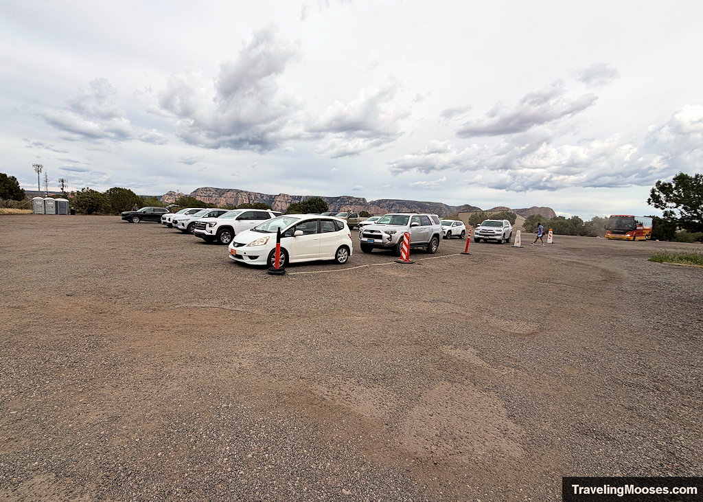 Spacious gravel parking lot at Sedona Airport Scenic Lookout with cars and parking buses in the lot
