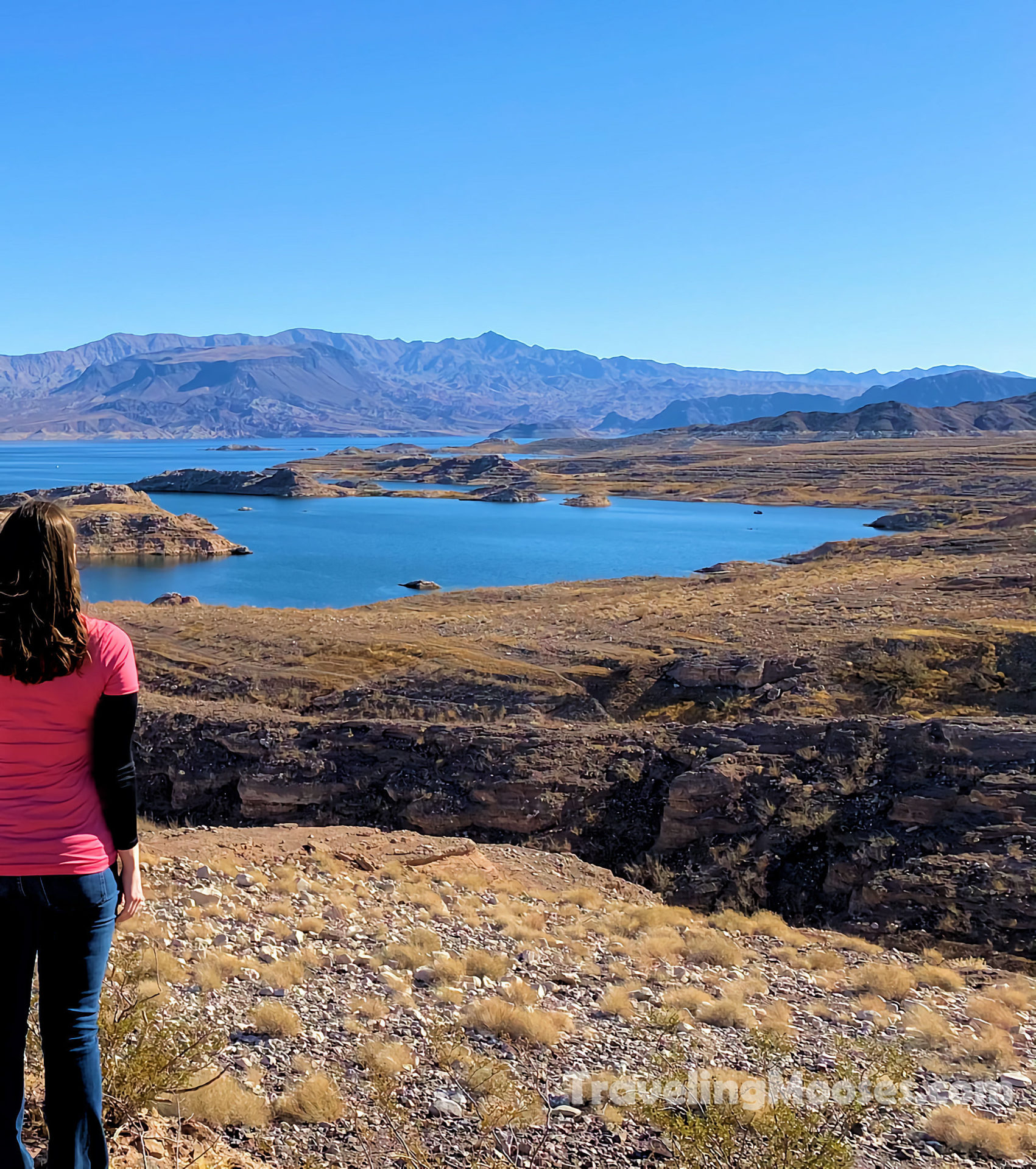 A woman staring off in the distance at Lake Mead's retreating waters.