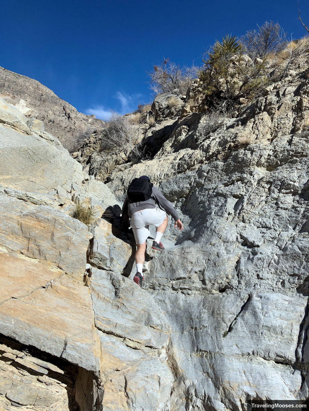 Man scrambling up gateway trail