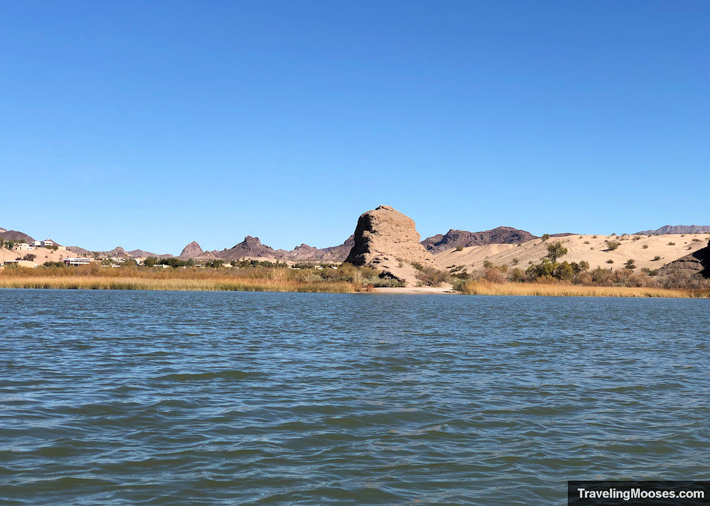 castle rock seen in the distance beyond a bay