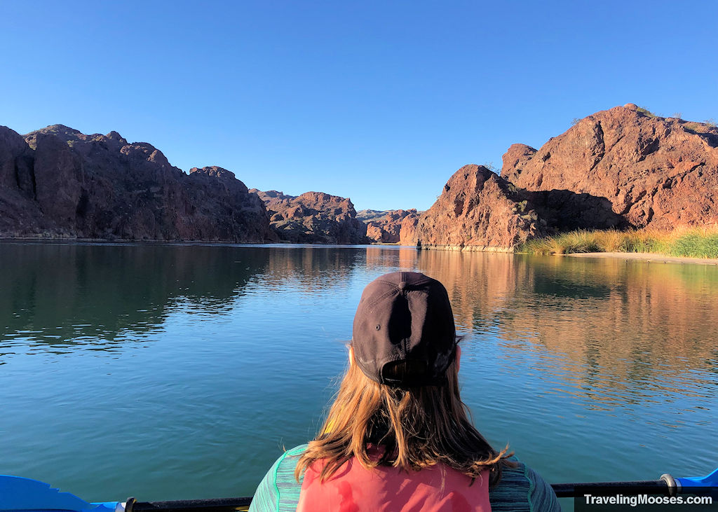 woman in a kayak staring off into topock gorge on a sunny day