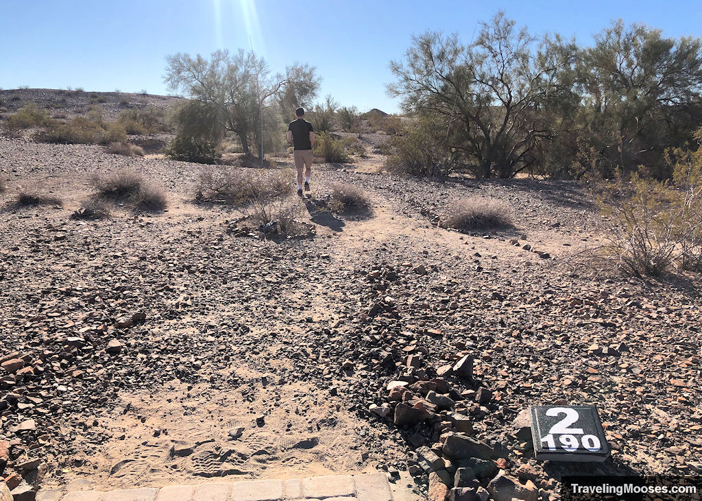 Man walking away from Teebox 2 at Sara Disc Golf course