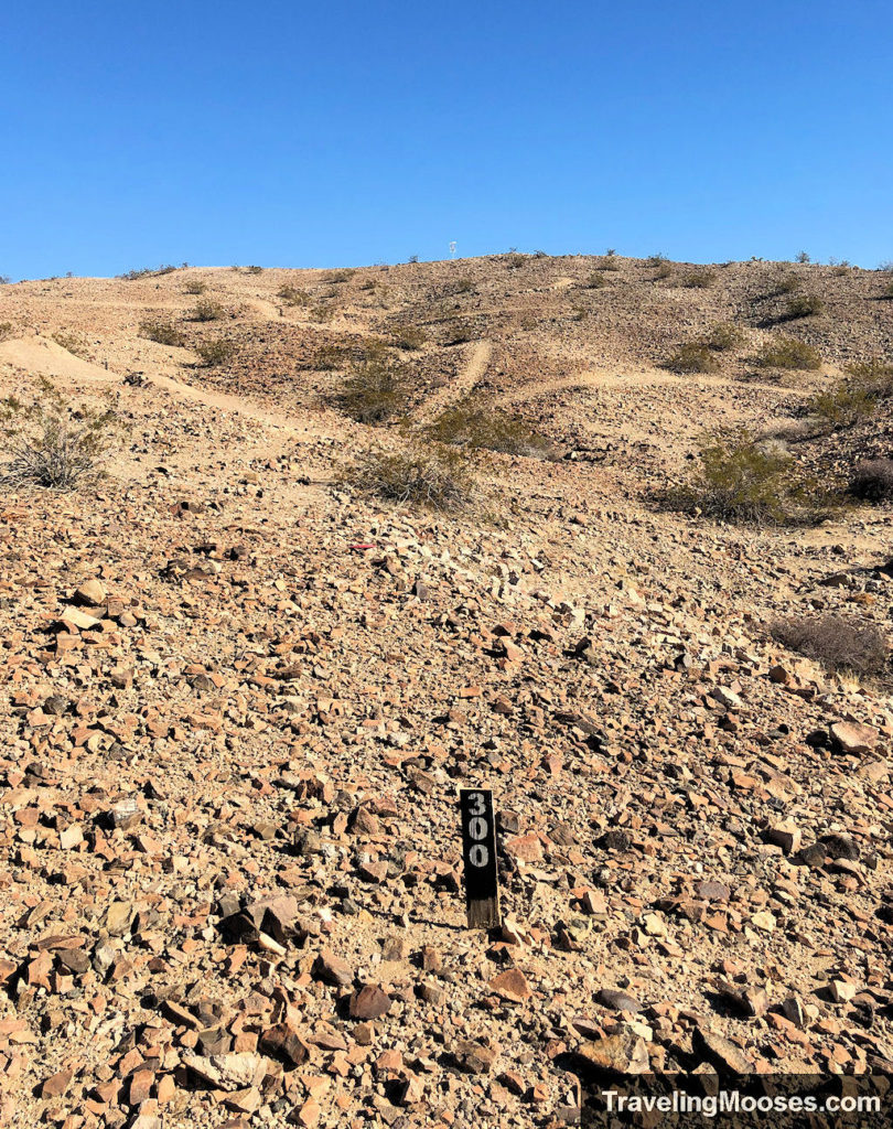 300 yard warning sign marker leading up a hill towards basket 11