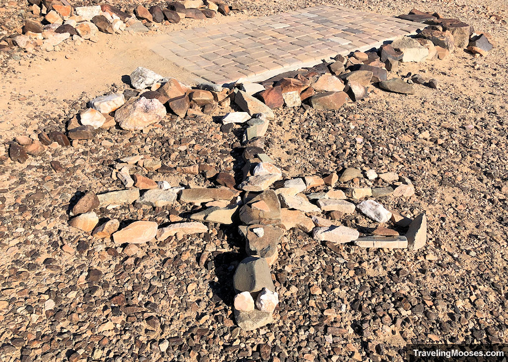 stones on the ground in the shape of a firefly