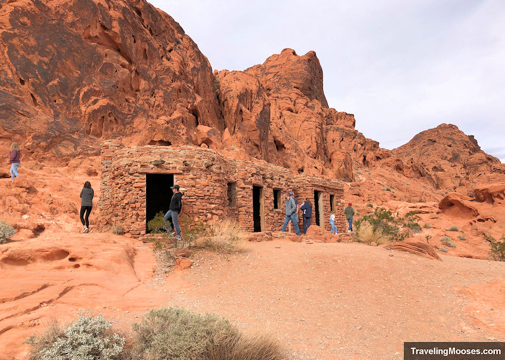 Crowds looking at old stone structures in the desert