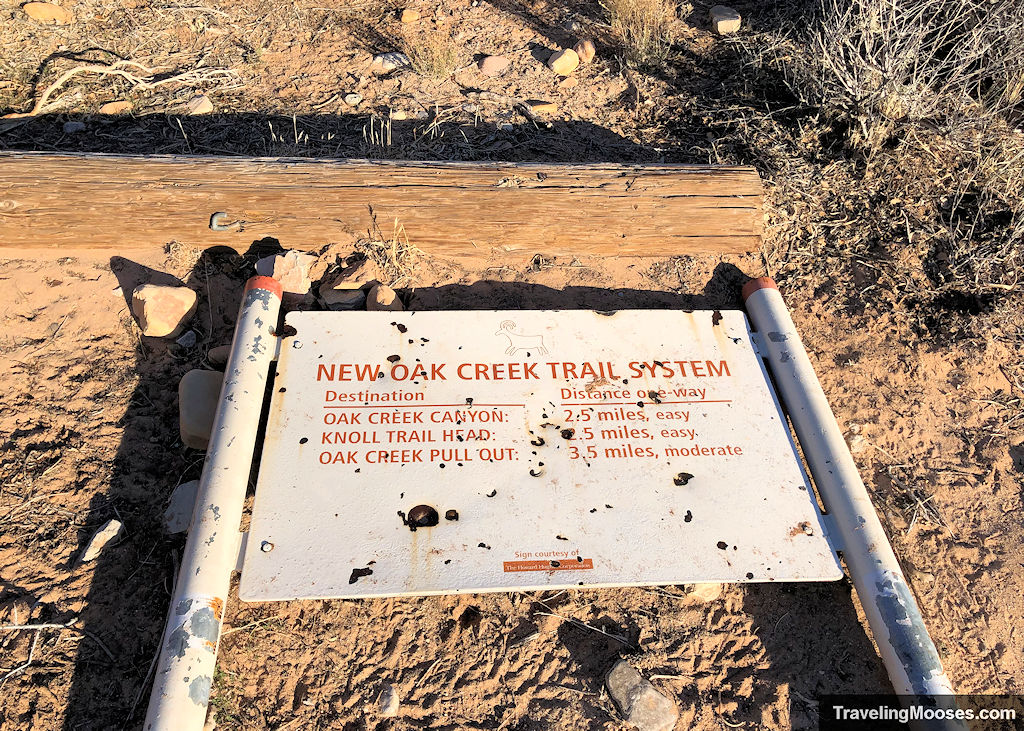 Fallen sign reading New Oak Creek Trail system