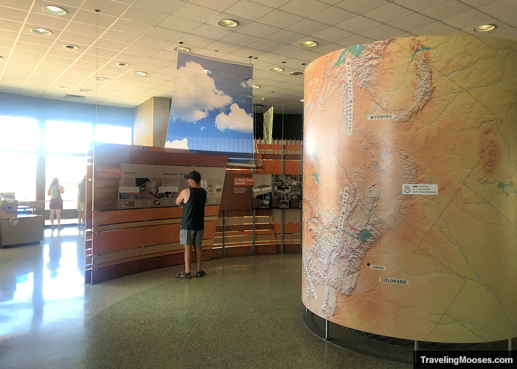 A man reading some of the many informational exhibits within the Carl Hayden Visitor Center.