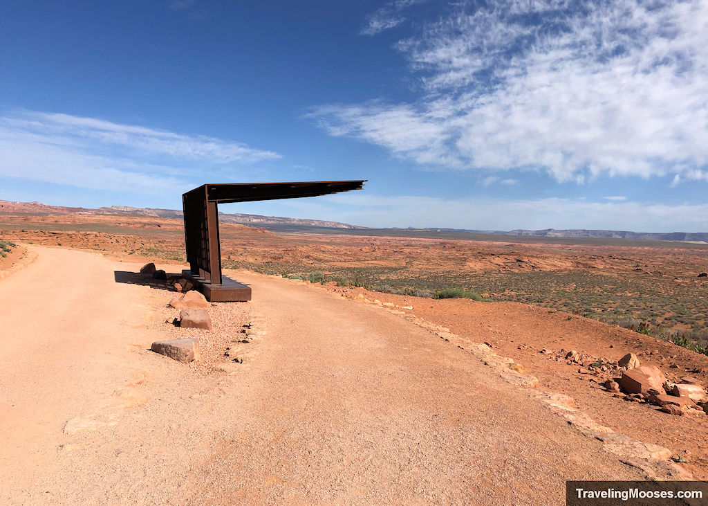 Rusty shelter meant to provide shade on a desert path