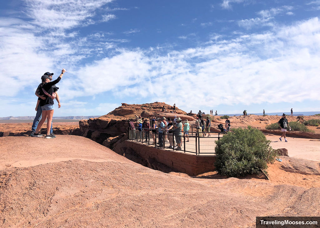Tourists gathered around a lookout area at Horseshoe Bend