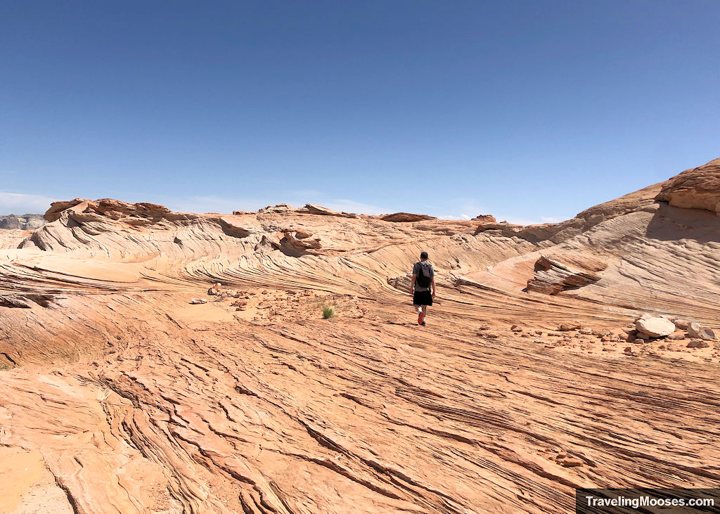 Man walking along sandstone