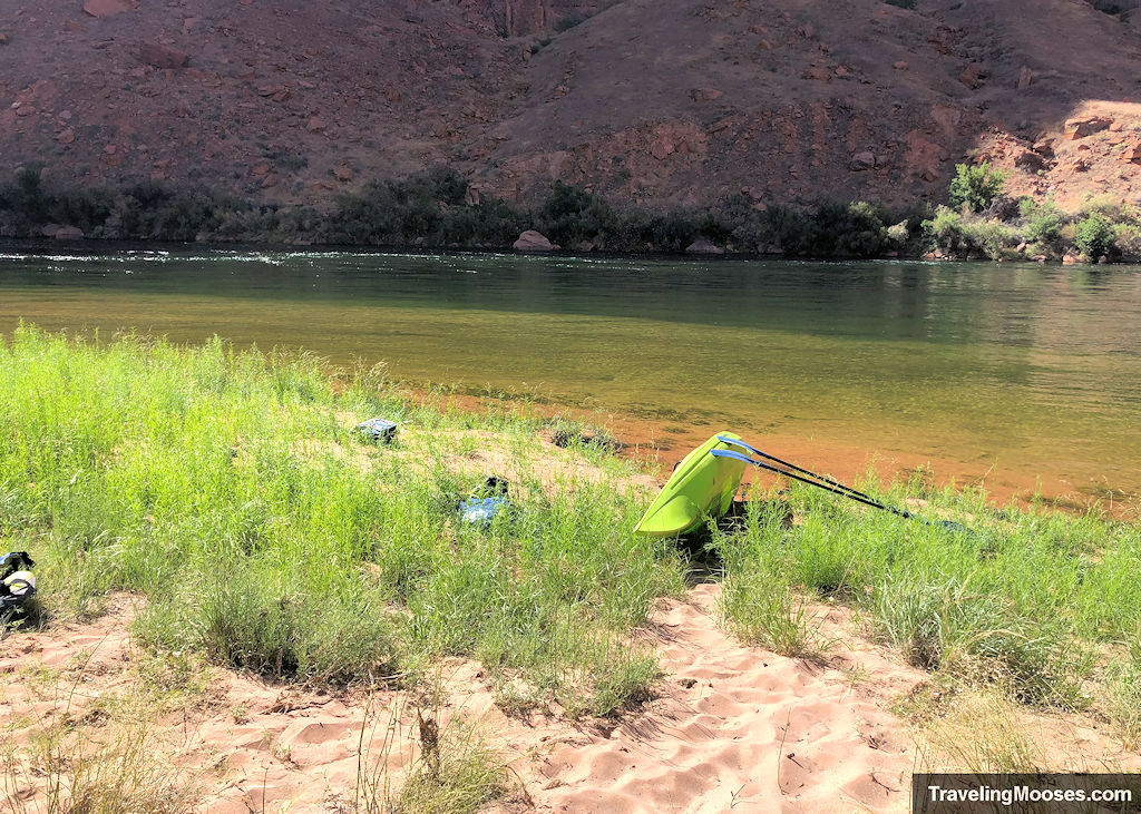 A kayak on its side near the shore of the colorado river