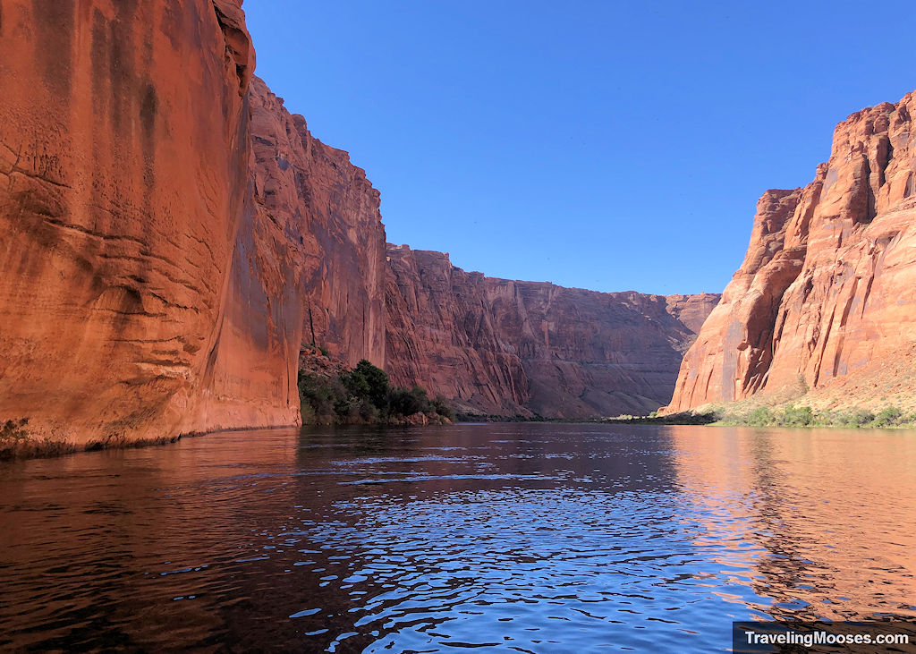 Colorado river winding through steep reddish colored canyon walls