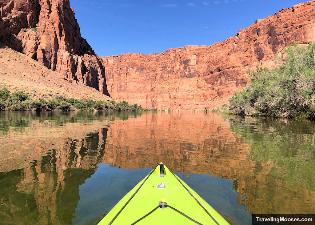 Bright yellow kayak floating through Glen Canyon