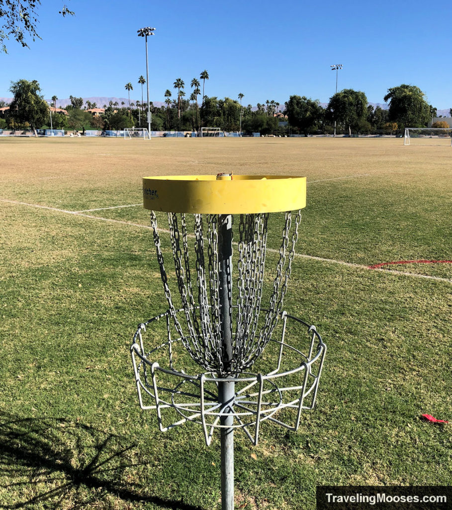 Yellow Rimmed Disc Golf Bucket shown on a soccer field