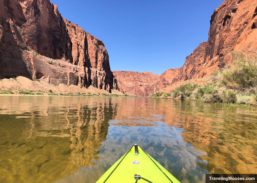 Yellow kayak tip gliding over calm clear waters of the Colorado River