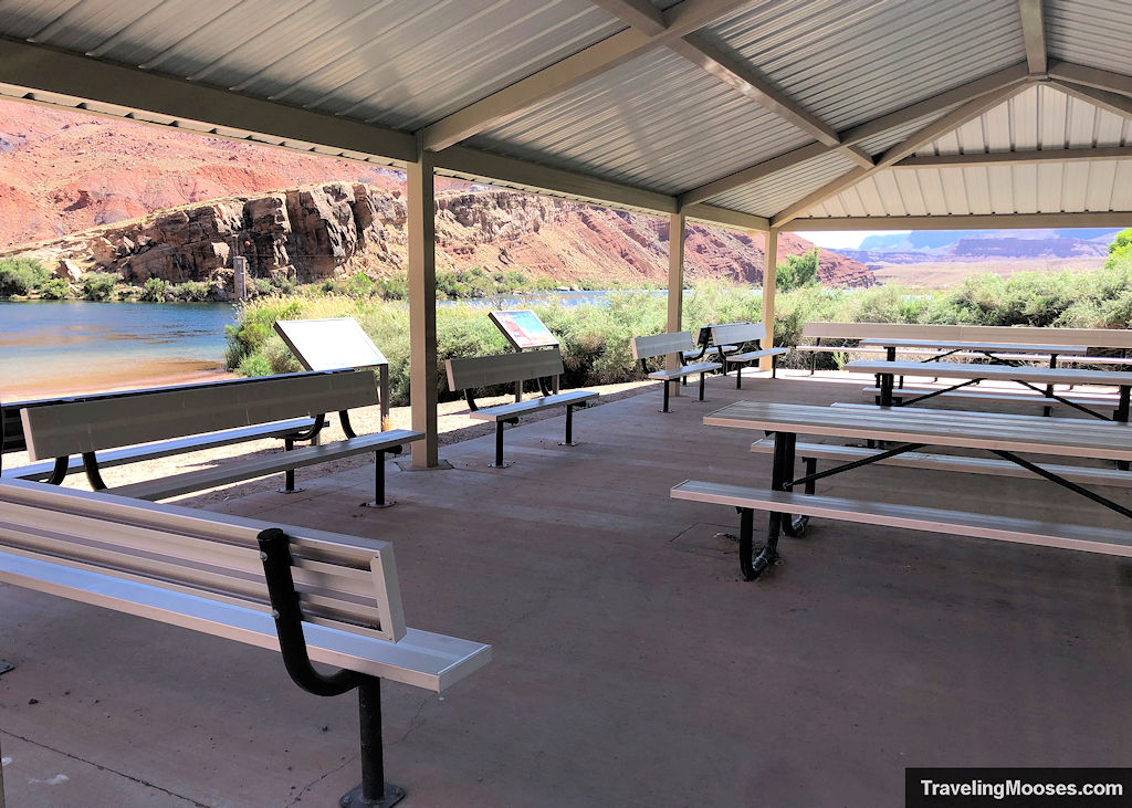 Metal Picnic tables and benches underneath a metal structure