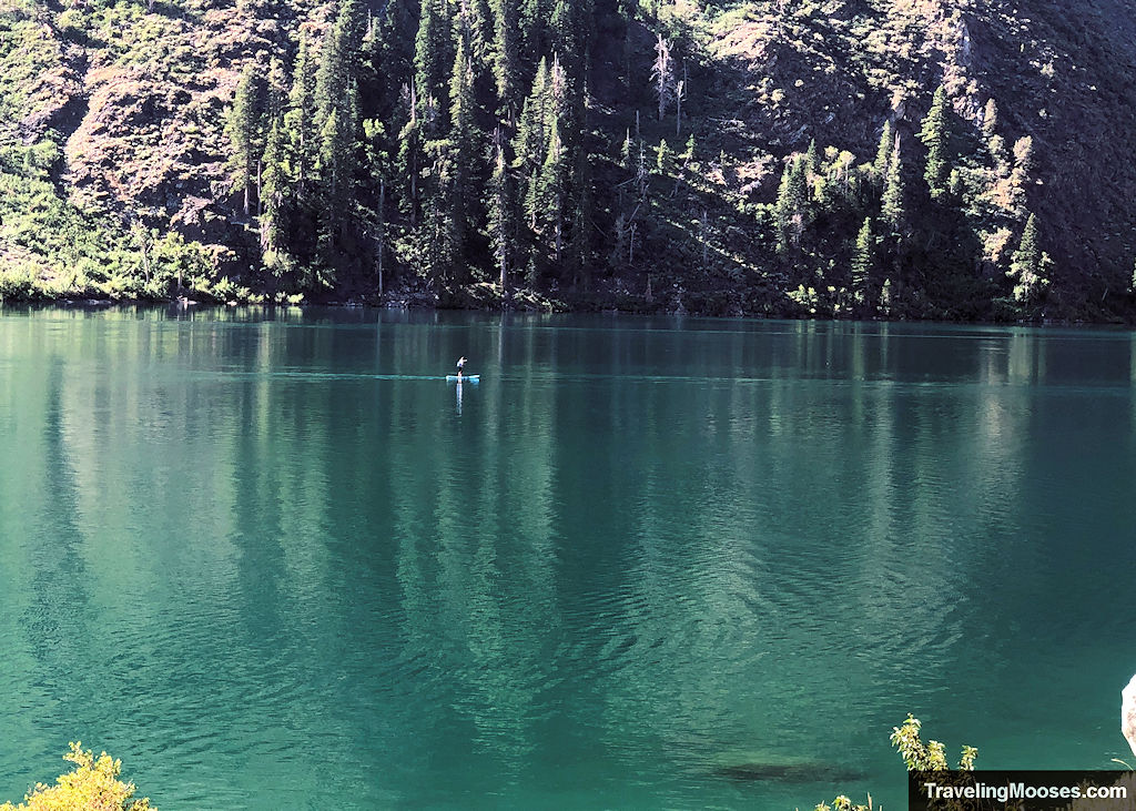 Paddleboarder seen on turqoise waters of Convict Lake