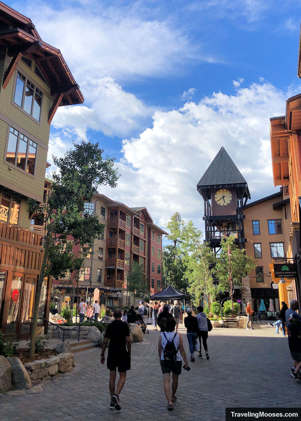 Mammoth Village Plaza with visitor walking around near the clocktower