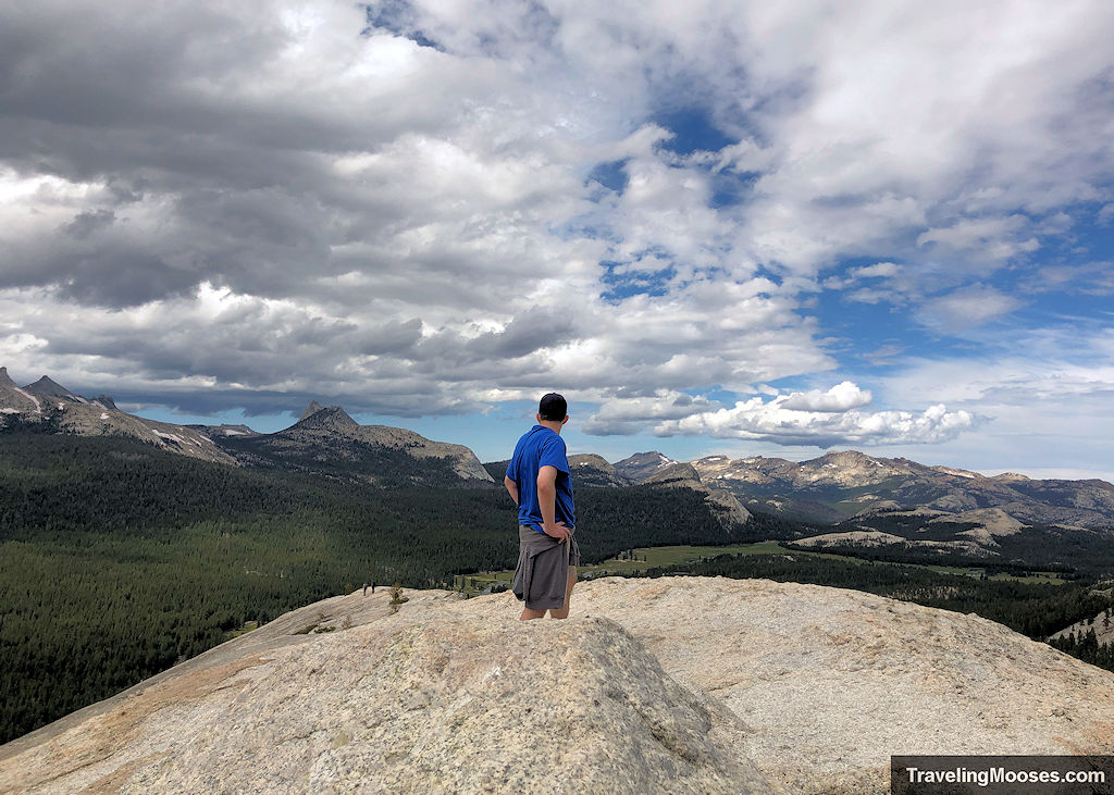 Man staring off in the distance overlooking sharp mountains in the Yosemite Valley