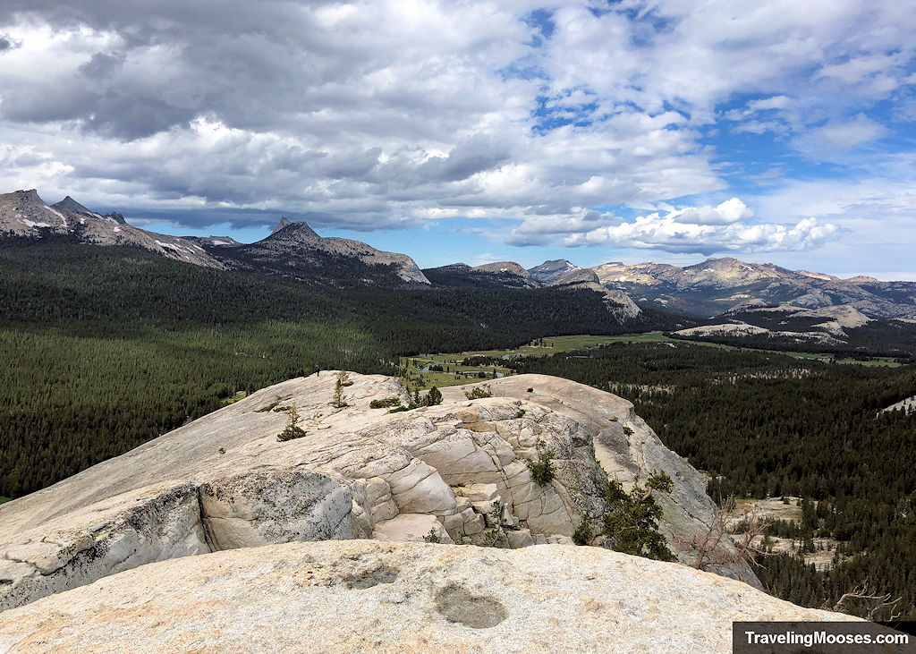 Summit of the granite stone dome with a lush meadow in the distance