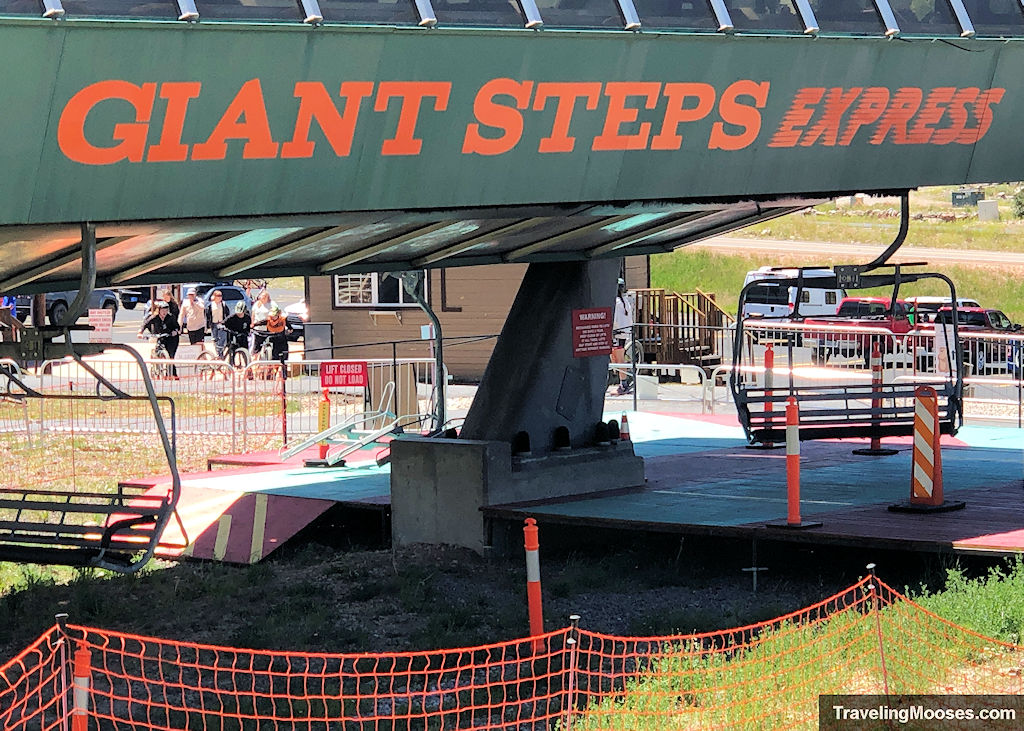 Giant Steps Express chairlift at Brian Head Resort with the loading area visible on a sunny summer day.