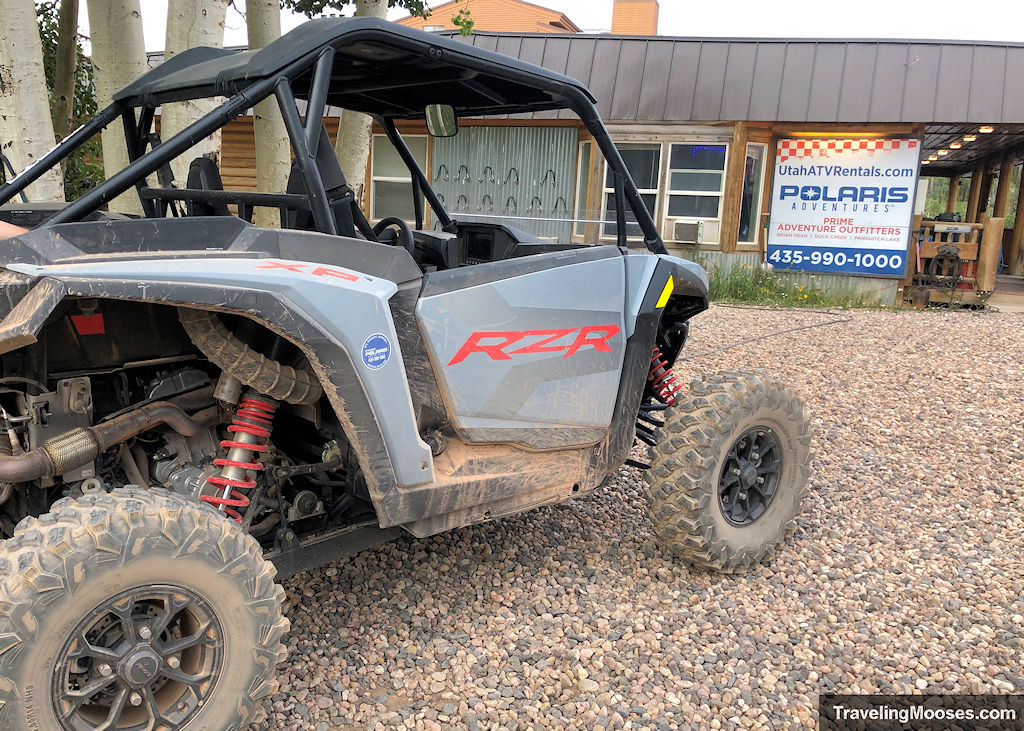 Dust-covered Polaris RZR rental in front of Prime Adventure Outfitters, starting point for the 4-hour OHV ride in Brian Head