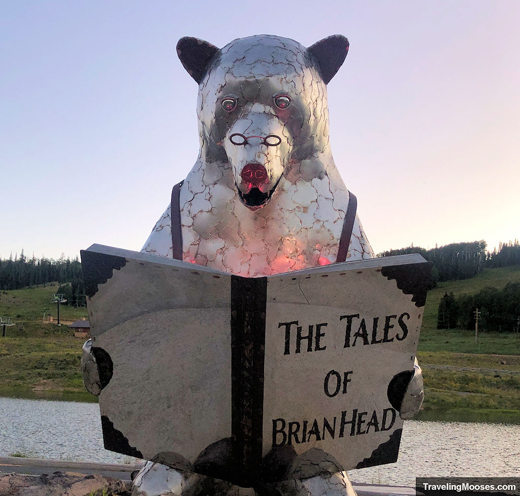 Metal Bear Statute reading a large book that is title "The Tales of Brian Head"