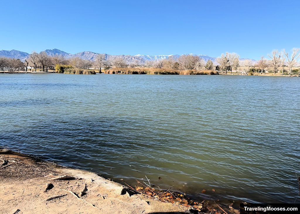 Expansive lake with a tall rugged snowcap mountains in the distance